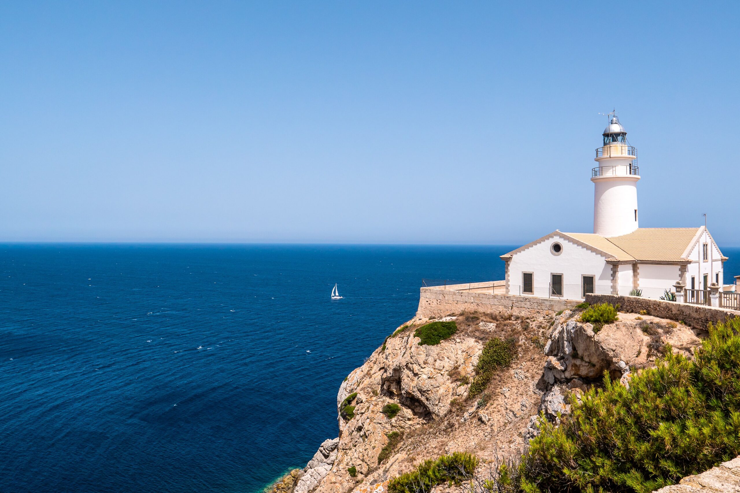 Small town in Spain by the seaside with a lighthouse
